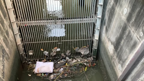 Canal spillway with trash stuck in filtering grate static shot 