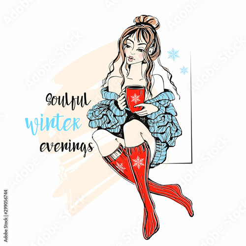 A girl in a sweater and knitted socks with a mug of hot tea. Soulful winter evenings. Inscription. Vector