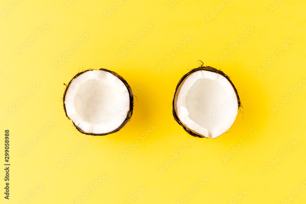 Fresh broken coconut on yellow background. Flat lay. Top view Fresh broken coconut on yellow background. Flat lay. Top view
