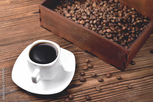 white coffee cup, morning side light coffee beans wooden box with coffee, top view natural wooden background