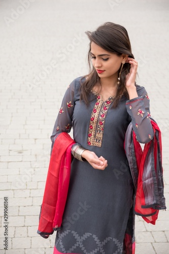 Portrait of an Indian young girl. Girl in traditional Indian clothing, salwar kameez. Girl traditional Indian decorations, bindi, chudiyan, jumka photo