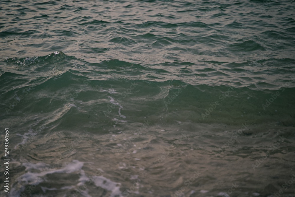Background texture of ocean calm waves with ripples on the surface of the sea water ,warm tone color, Sea background ocean beautiful nature water waves horizon surface texture. Background texture of ocean calm waves with ripples on the surface of the sea water ,warm tone color, Sea background ocean beautiful nature water waves horizon surface texture.