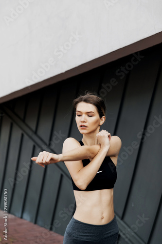fitness, sport, training and lifestyle concept - smiling woman stretching hand outdoors