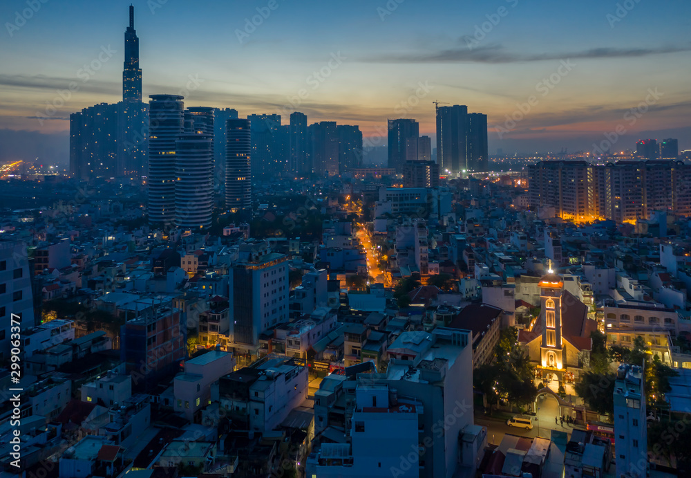 Five o'clock, early morning aerial urban view binh thanh district of Ho Chi Minh City featuring a french colonial church, streets and high rise buildings and majestic sky