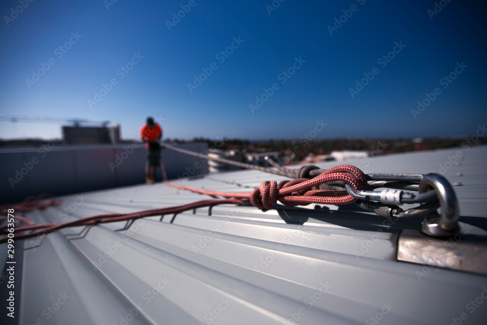 Rope access height safety carabiners connecting with figure of eight knots  rigging, clipping into roof fall arrest and fall restraint anchor point  systems ready to ascending, construction site Sydney Stock Photo