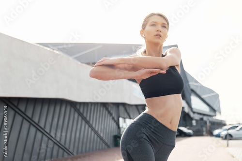 fitness, sport, training and lifestyle concept - woman stretching outdoors