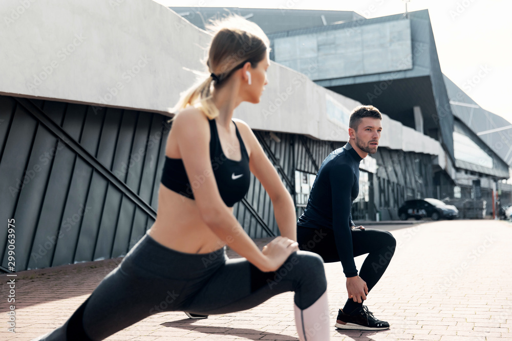 Obraz premium fitness, sport, training and lifestyle concept - man and woman stretching outdoors