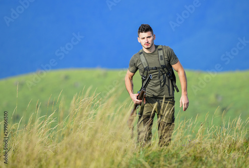 Action Target. man hold weapon. soldier in the field. polygon. military style. male in camouflage. army forces. sniper reach target mountain. purpose and success. man ready to fire. hunter hobby