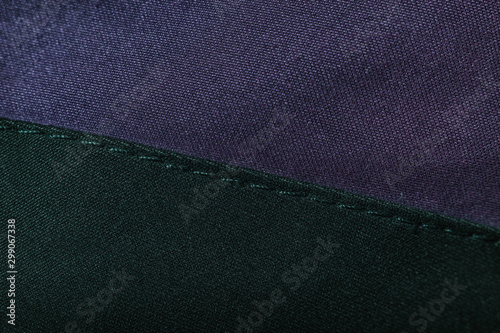 Close up beautiful  purple and black textile cloth texture background with stitching. Macro photography background material view.