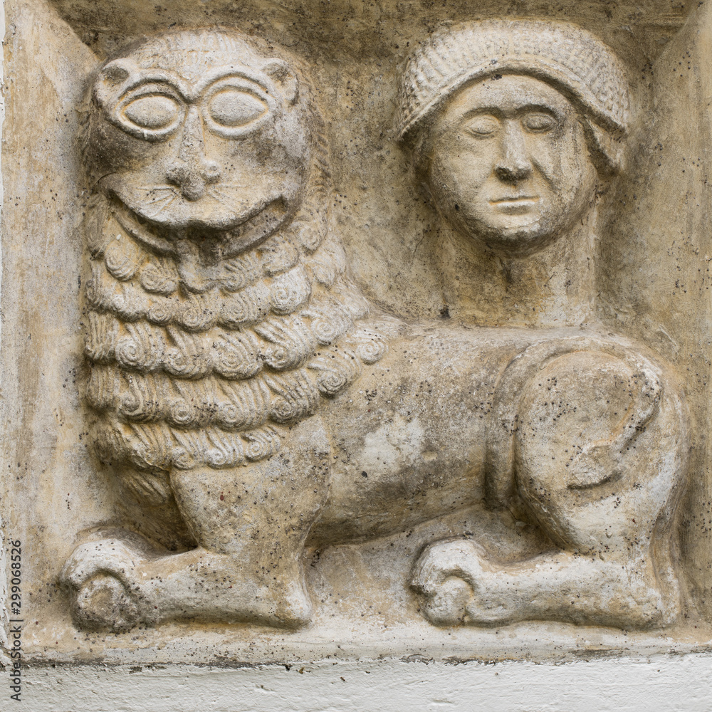 ancient greco roman relief of mythical lion and human head build into wall