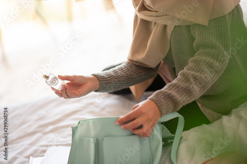 Close up of girl taking a pack of nice perfume