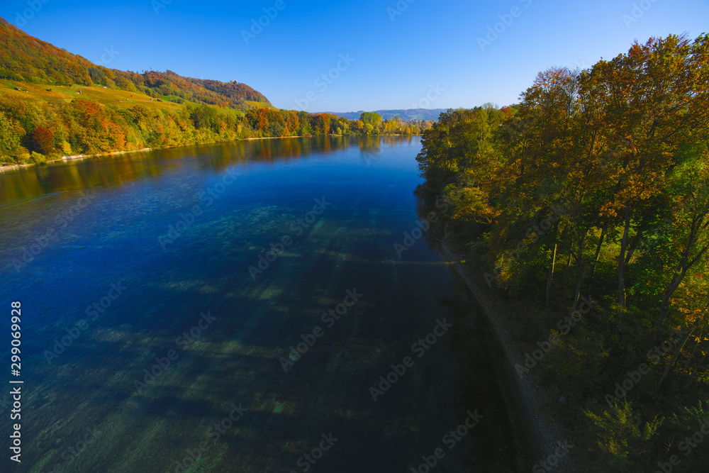 The river Rhine, only a few hundred meters young, after leaving Lake Constance. Autumn. Near the Swiss town Stein am Rhein. View from the car bridge to the west, the road leads to the Rhine Falls.