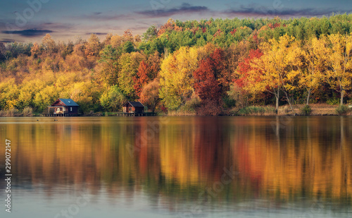 Wooden houses in autumn nature