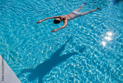 Woman face down in a swimming pool