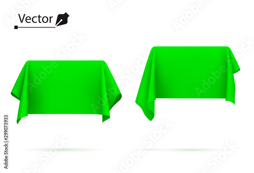 Object covered with green silk cloth. Box, rectangle. Surprise, award, prize, presentation concept. Reveal a hidden object. 