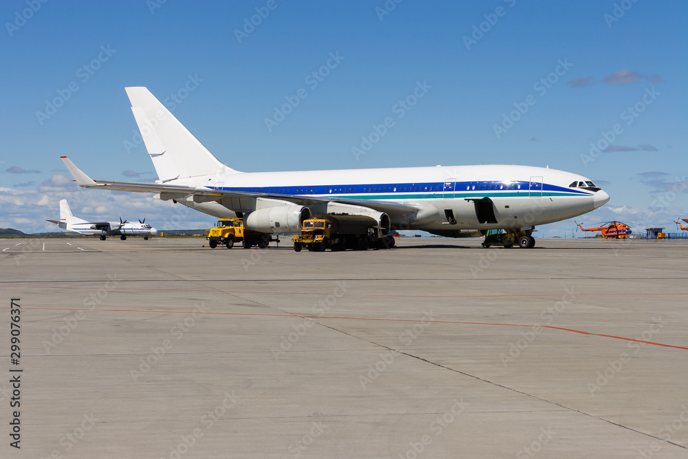 Airplane parking at the airport. Large wide-body aircraft near the runway. Airplane parking at the airport. Large wide-body aircraft near the runway.