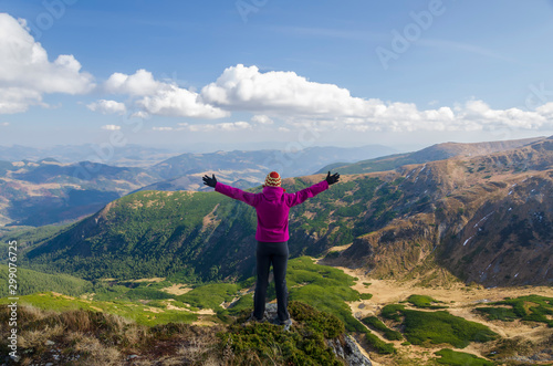 Happy female tourist in the mountains