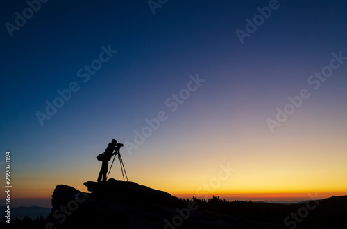Photographer capturing sunset landscape