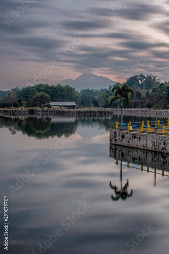 Panoramic reflection, Beautiful scenery Tambakboyo dam at sunrise with motion clouds photo