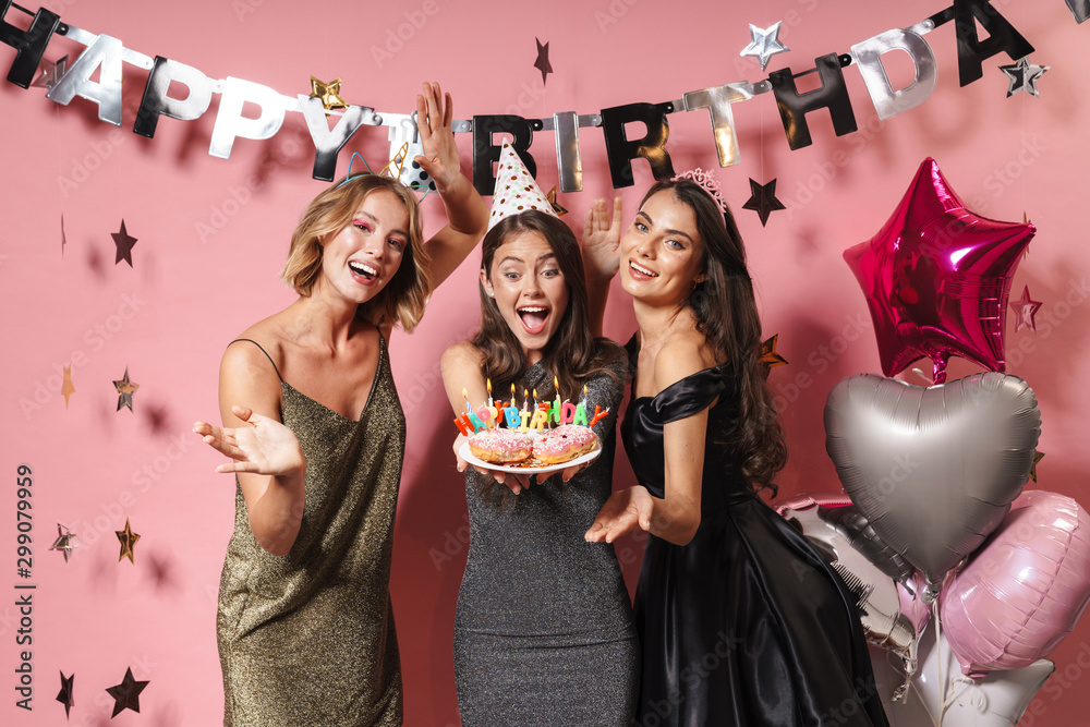 Φωτογραφία Image of beautiful party girls holding birthday cake with candles
