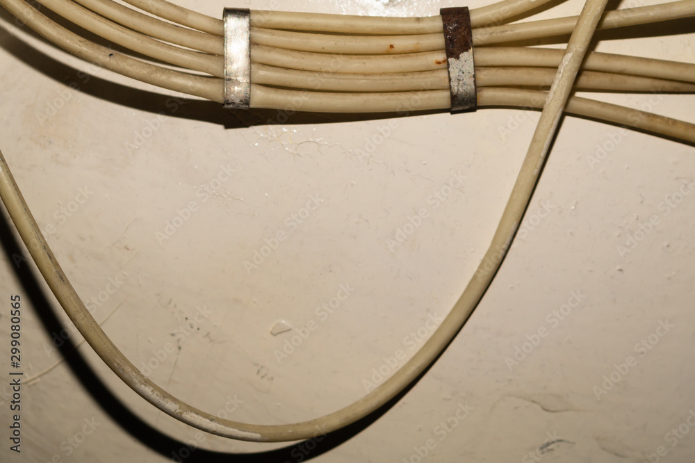 Electrical wires or cables hanging on wall. industrial background