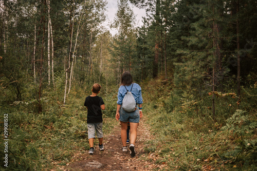 two people walking in forest