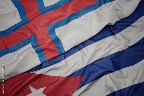 waving colorful flag of cuba and national flag of faroe islands.