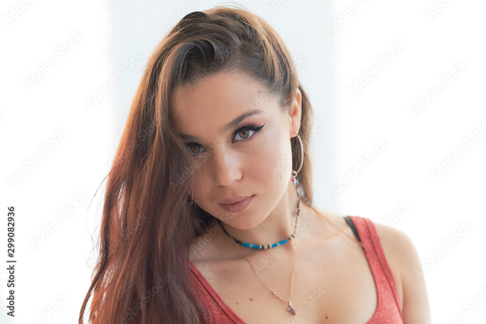 beautiful woman with a serious face isolated on gray background beautiful woman with a serious face isolated on gray background