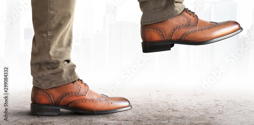 Man takes a step in classic leather shoes photo