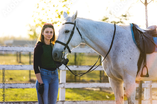 The owner and his white horse are preparing to ride.Stock photo