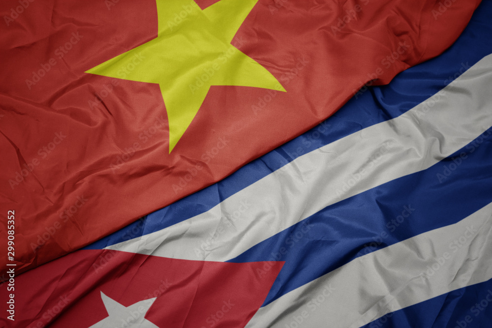 waving colorful flag of cuba and national flag of vietnam.