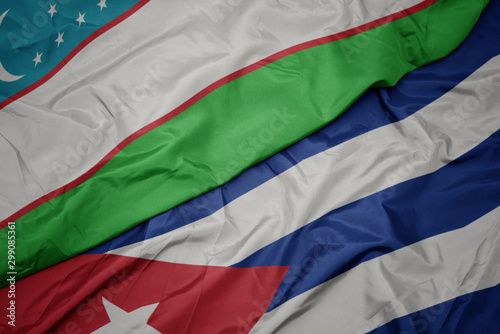 waving colorful flag of cuba and national flag of uzbekistan.