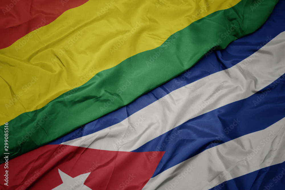 waving colorful flag of cuba and national flag of bolivia.