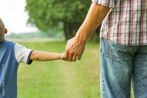 the parent holds the hand of a l child