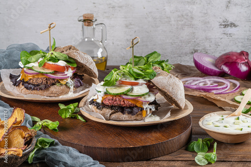 Healthy vegan burger with fresh vegetables and yogurt sauce