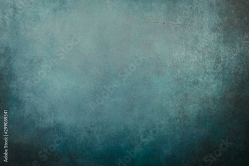 Blue grungy backdrop with dark vignette borders