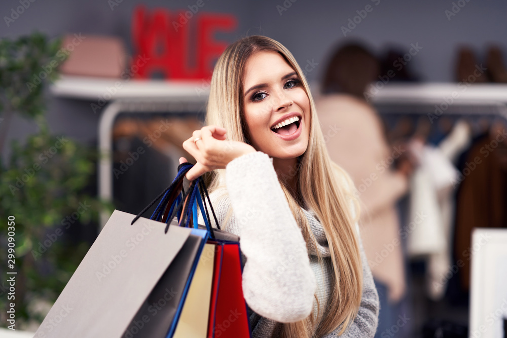 Adult women shopping for clothes in boutique in autumn
