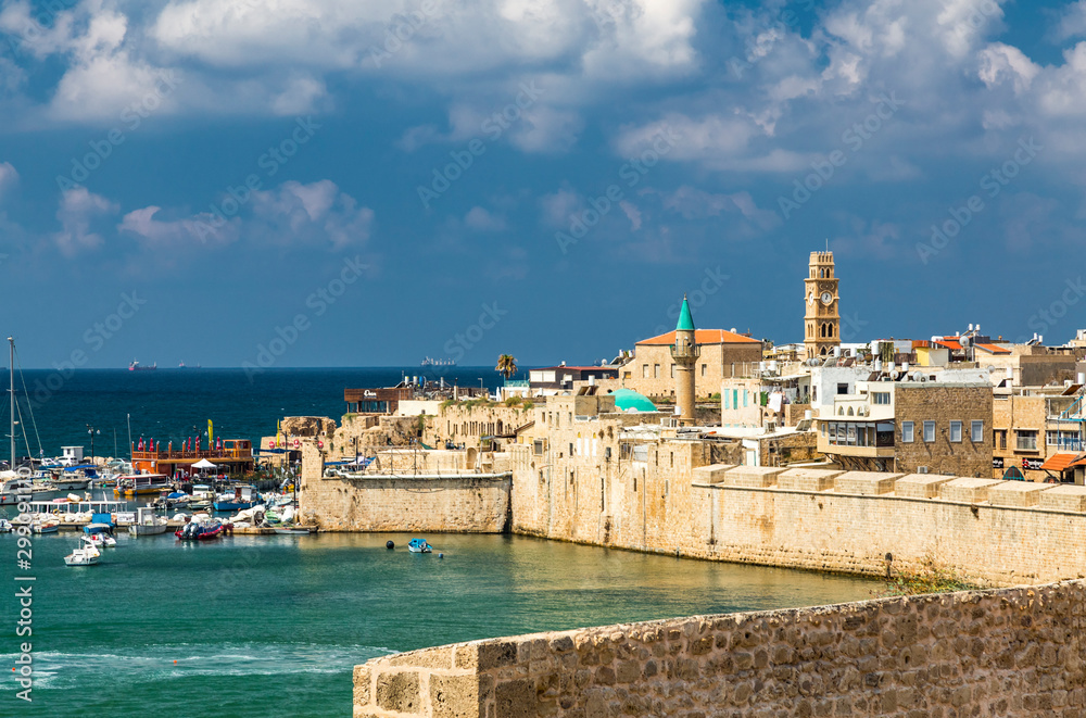  View on marina with yachts and ancient walls of harbor in Acre or Akko, Israel.