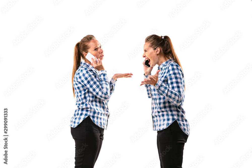 Young handsome woman arguing with herself on white studio background. Concept of human emotions, expression, mental issues, internal conflict, split personality. Half-length portrait. Negative space. Young handsome woman arguing with herself on white studio background. Concept of human emotions, expression, mental issues, internal conflict, split personality. Half-length portrait. Negative space.