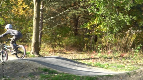 Boy riding a bicycle on a pumptrack photo