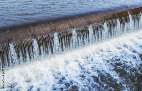Canvas Print Water cascade streaming down a lasher of dam, water saving concept