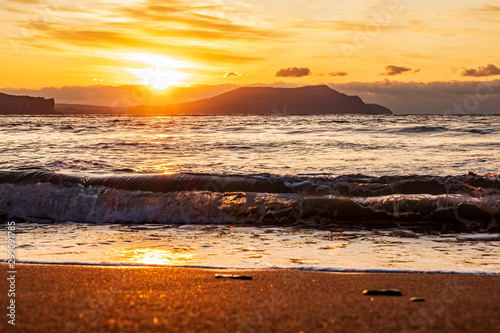 Fototapeta Naklejka Na Ścianę i Meble -  picturesque sunrise over the Black Sea, waves roll on the sand