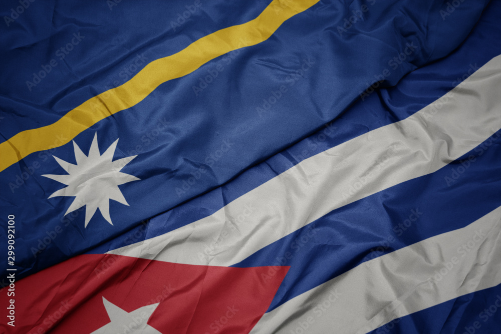 Naklejka premium waving colorful flag of cuba and national flag of Nauru .