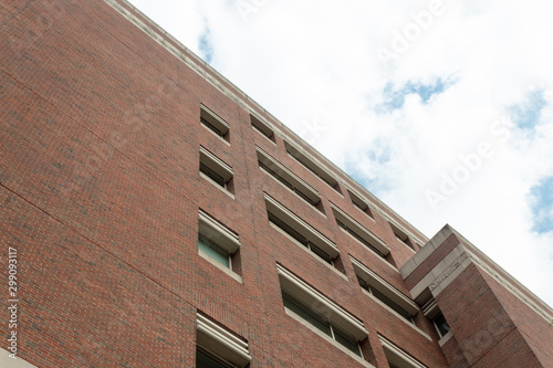 Plain brick facade of featureless generic office building, horizontal aspect © Natalie Schorr