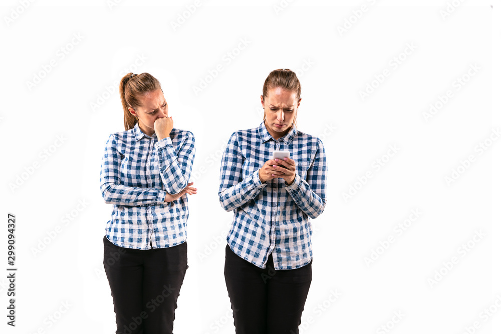 Young handsome woman arguing with herself on white studio background. Concept of human emotions, expression, mental issues, internal conflict, split personality. Half-length portrait. Negative space. Young handsome woman arguing with herself on white studio background. Concept of human emotions, expression, mental issues, internal conflict, split personality. Half-length portrait. Negative space.