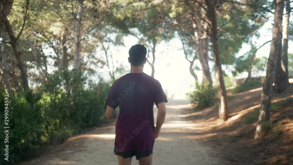 Male runner on nature road in forest, man running in park, sport run training, spanish football player Male runner on nature road in forest, man running in park, sport run training, spanish football player