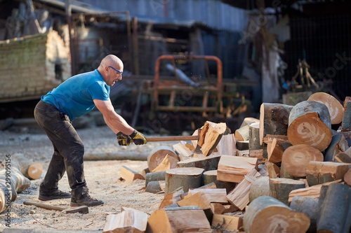 Lumberjack splitting wood with an axe