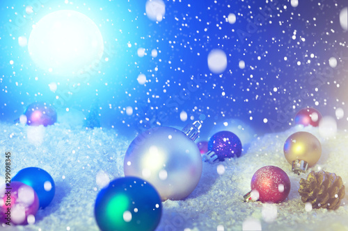 Beautiful Christmas Balls on the Snow in Night. Christmas Background. The elements of this image furnished by NASA