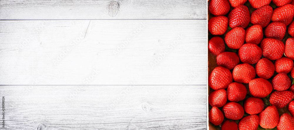 Fresh juicy strawberries wide banner or panorama concept. Red strawberry on white wooden board. - obrazy, fototapety, plakaty 