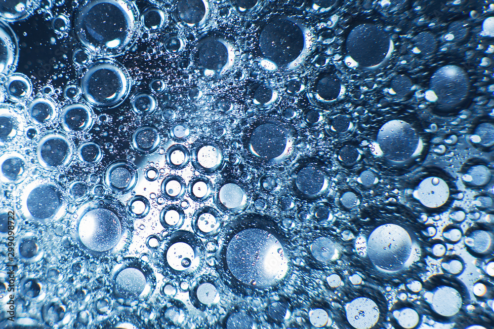 abstract light blue background with oil circles . bubbles of water close up . oil bubbles in the water macro. circle bubbles background abstract light blue background with oil circles . bubbles of water close up . oil bubbles in the water macro. circle bubbles background